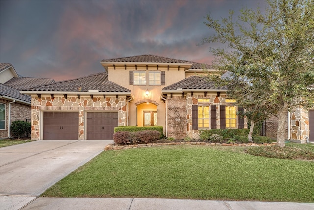 107 Lake View Loop, Fulshear, TX 77441 - mediterranean / spanish-style home with an attached garage, a front lawn, concrete driveway, stucco siding, and a tiled roof