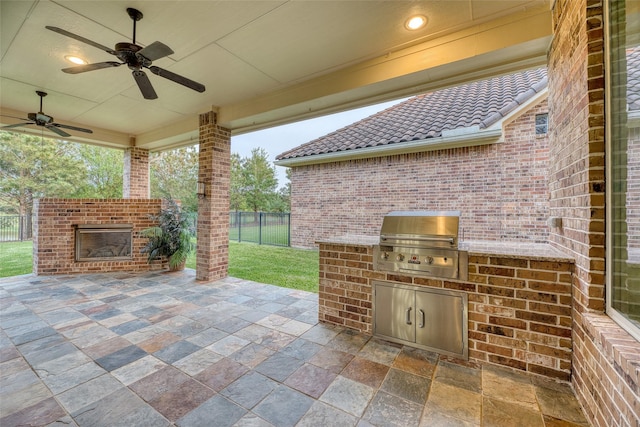 107 Lake View Loop, Fulshear, TX 77441 - view of patio / terrace with a brick fireplace, exterior kitchen, and a ceiling fan