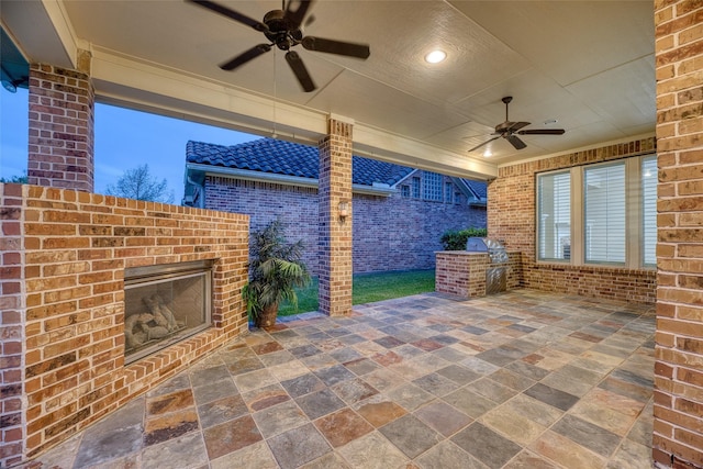 107 Lake View Loop, Fulshear, TX 77441 - view of patio / terrace with an outdoor brick fireplace, ceiling fan, and exterior kitchen