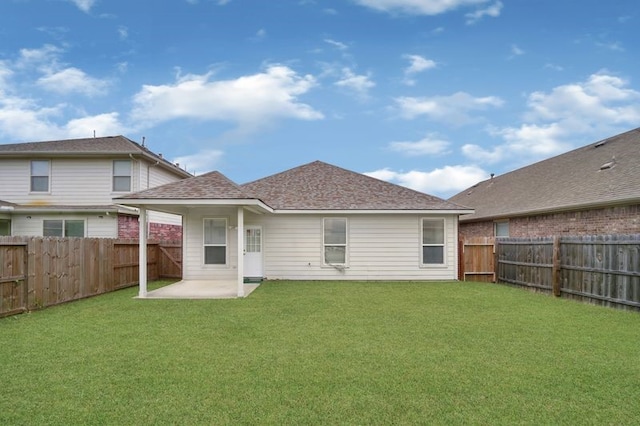 15806 Marble Bluff Ln, Houston, TX 77049 - back of house with a fenced backyard, a patio area, and a shingled roof
