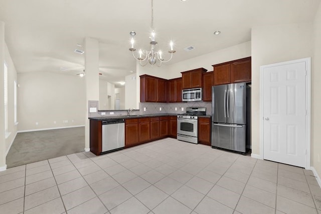 15806 Marble Bluff Ln, Houston, TX 77049 - kitchen with stainless steel appliances, a chandelier, dark countertops, decorative backsplash, and decorative light fixtures