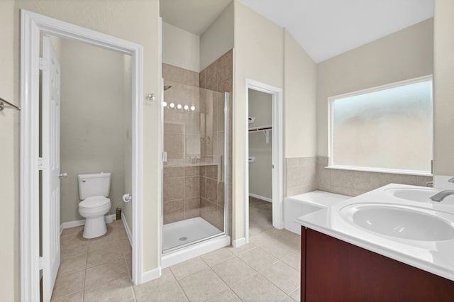 15806 Marble Bluff Ln, Houston, TX 77049 - bathroom with a stall shower, tile patterned floors, double vanity, and a spacious closet
