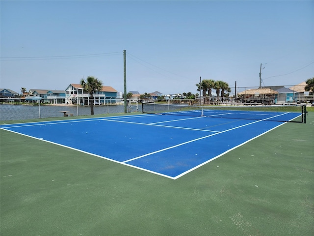 21446 Gulf Dr, Galveston, TX 77554 - view of tennis court featuring a residential view
