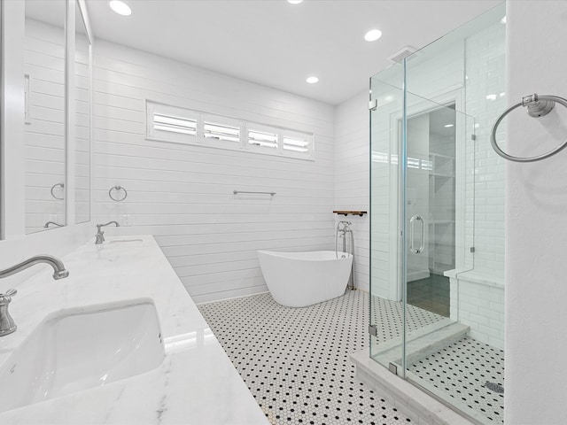 1110 W 12th St, Houston, TX 77008 - bathroom with a shower stall, a freestanding bath, double vanity, recessed lighting, and tile patterned flooring