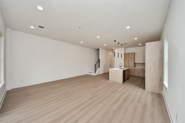 431 Neyland St, Houston, TX 77022 - unfurnished living room with recessed lighting, light wood finished floors, and stairs