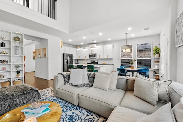 2824 Jehlon Ln, Conroe, TX 77385 - living area featuring dark wood-style flooring and recessed lighting