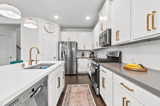 2824 Jehlon Ln, Conroe, TX 77385 - kitchen featuring appliances with stainless steel finishes, white cabinets, recessed lighting, backsplash, and decorative light fixtures