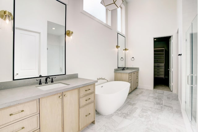 1514 Chantilly Ln, Houston, TX 77018 - bathroom featuring a towering ceiling, two vanities, a stall shower, a freestanding tub, and marble finish floors