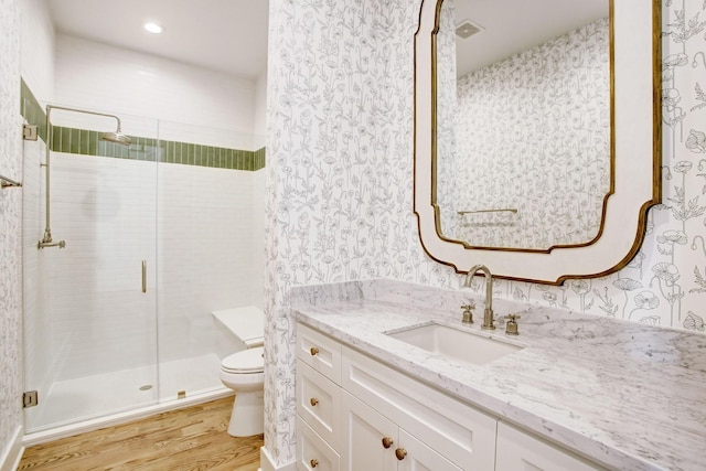1514 Chantilly Ln, Houston, TX 77018 - bathroom with wood finished floors, vanity, wallpapered walls, a stall shower, and recessed lighting