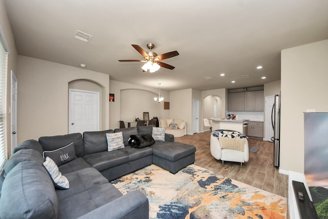 7947 Cinderella St, Houston, TX 77028 - living room featuring arched walkways, light wood-style flooring, a ceiling fan, and recessed lighting