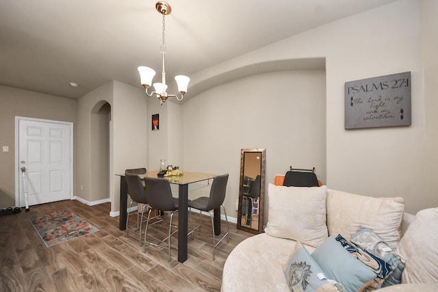 7947 Cinderella St, Houston, TX 77028 - dining room with arched walkways, a chandelier, and wood finished floors