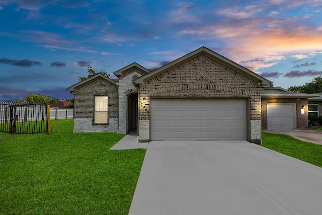 7947 Cinderella St, Houston, TX 77028 - french country home featuring an attached garage, driveway, stone siding, and brick siding