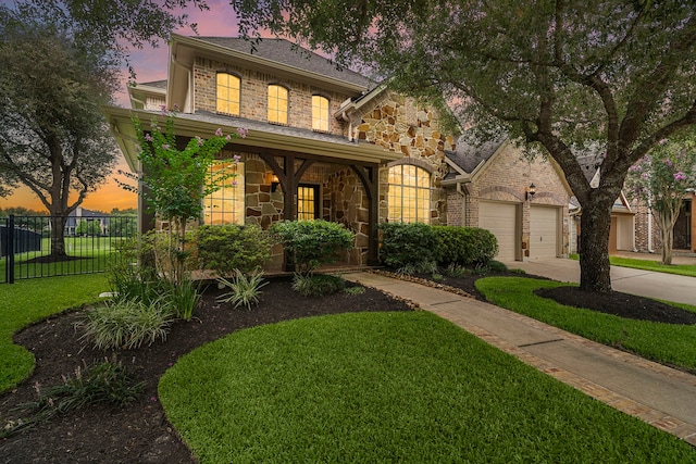 18331 Chapmans Count Rd, Cypress, TX 77433 - view of front of home featuring stone siding, driveway, and covered porch