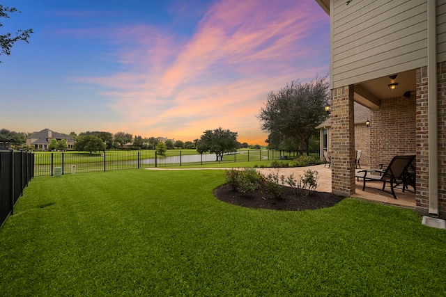18331 Chapmans Count Rd, Cypress, TX 77433 - yard at dusk featuring a patio, a water view, and a fenced backyard