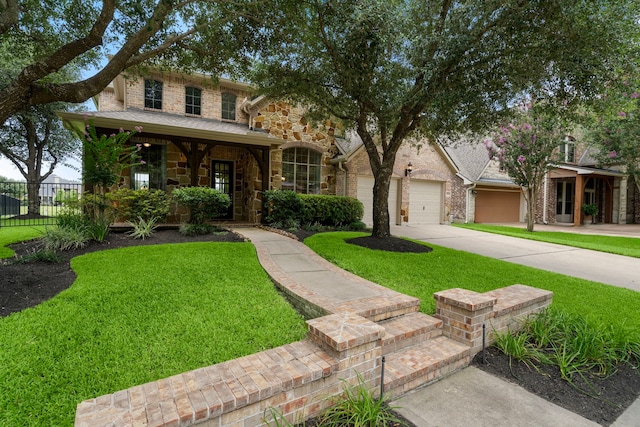 18331 Chapmans Count Rd, Cypress, TX 77433 - view of front of house with concrete driveway, stone siding, a garage, and covered porch