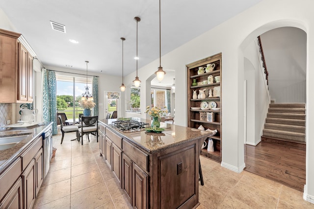 18331 Chapmans Count Rd, Cypress, TX 77433 - kitchen featuring appliances with stainless steel finishes, a kitchen island, built in features, dark stone counters, and recessed lighting