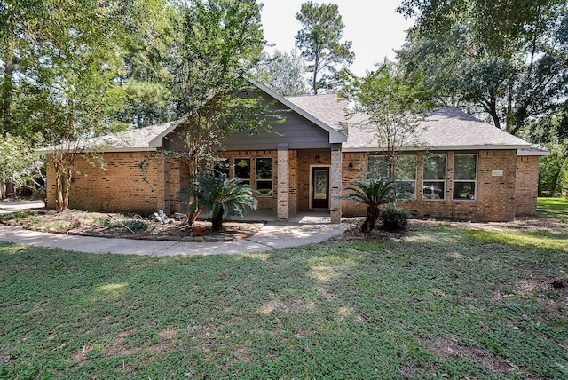 18110 Auburn Dr, Tomball, TX 77375 - view of front of home with brick siding, a front lawn, and a shingled roof