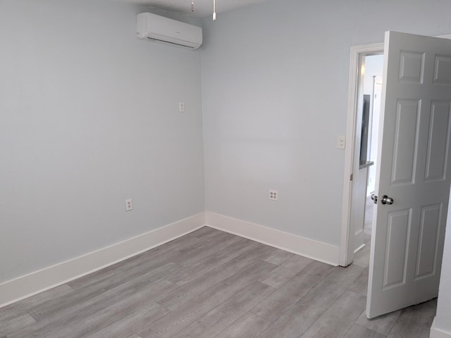 1805 39th St, Galveston, TX 77550 - unfurnished room with a wall mounted air conditioner and wood finished floors