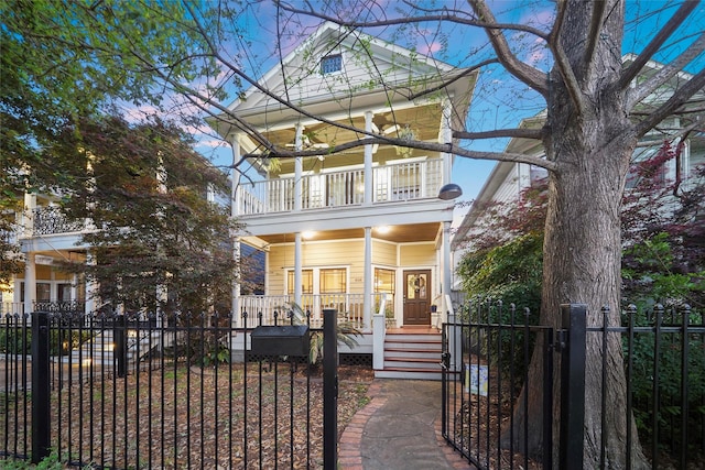 606 E 27th St, Houston, TX 77008 - view of front of property featuring covered porch, a balcony, a fenced front yard, and a gate