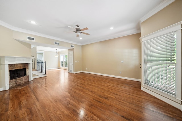 606 E 27th St, Houston, TX 77008 - unfurnished living room featuring ceiling fan, ornamental molding, stairway, wood finished floors, and a fireplace
