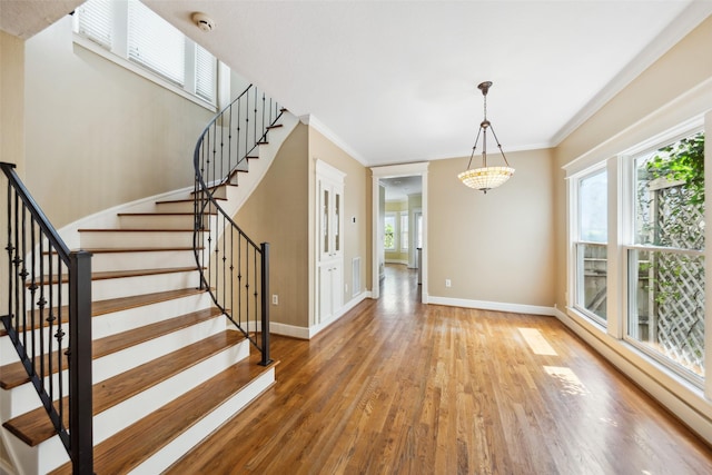 606 E 27th St, Houston, TX 77008 - stairway with wood finished floors, a baseboard radiator, and ornamental molding