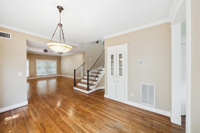 606 E 27th St, Houston, TX 77008 - entrance foyer with ornamental molding, stairs, light wood-type flooring, and ceiling fan