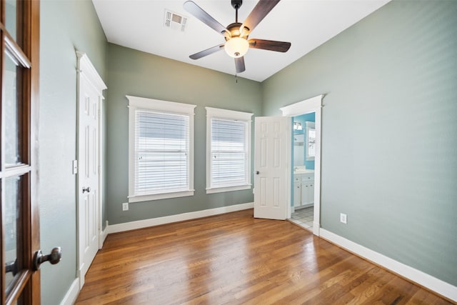 606 E 27th St, Houston, TX 77008 - unfurnished bedroom with wood finished floors, ensuite bath, and a ceiling fan