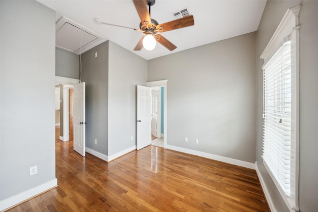 606 E 27th St, Houston, TX 77008 - unfurnished bedroom featuring attic access, wood finished floors, and ceiling fan