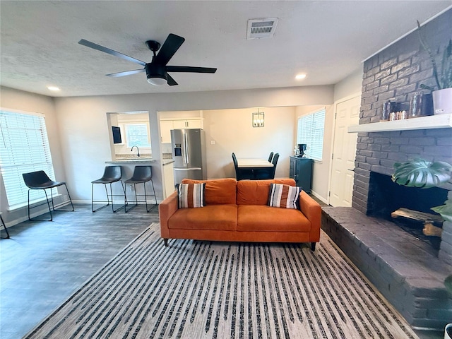 4822 Glendower Dr, Spring, TX 77373 - living room featuring ceiling fan, wood finished floors, healthy amount of natural light, a brick fireplace, and recessed lighting
