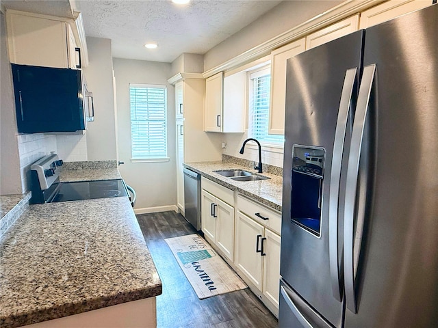 4822 Glendower Dr, Spring, TX 77373 - kitchen featuring appliances with stainless steel finishes, dark wood-type flooring, a textured ceiling, tasteful backsplash, and recessed lighting