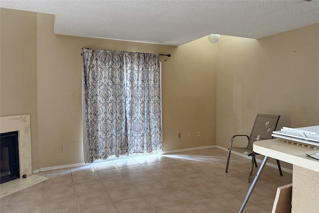 3600 Jeanetta St Unit 1602, Houston, TX 77063 - unfurnished living room with a textured ceiling, tile patterned flooring, and a fireplace