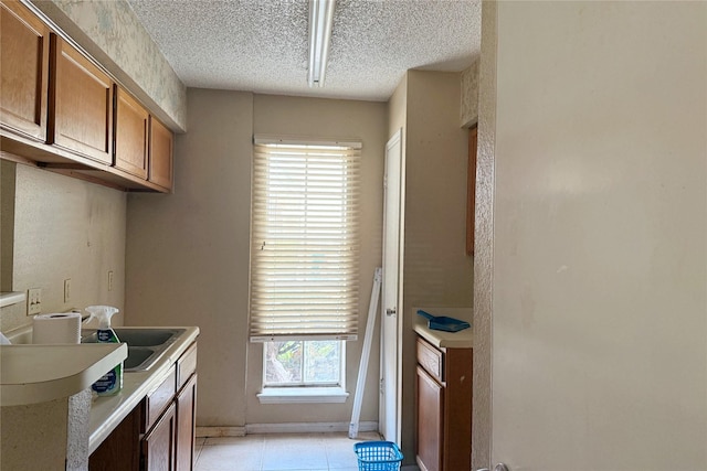 3600 Jeanetta St Unit 1602, Houston, TX 77063 - kitchen featuring brown cabinetry, a textured ceiling, and light countertops