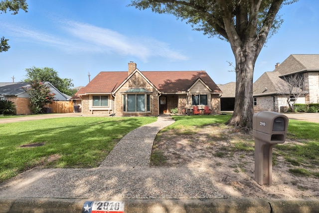2910 Riata Ln, Houston, TX 77043 - view of front of house featuring a front lawn, a chimney, and brick siding