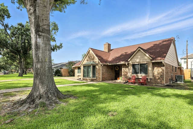 2910 Riata Ln, Houston, TX 77043 - view of front of property with brick siding, a front lawn, a chimney, and roof with shingles