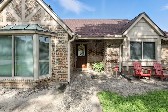 2910 Riata Ln, Houston, TX 77043 - doorway to property featuring brick siding and a shingled roof