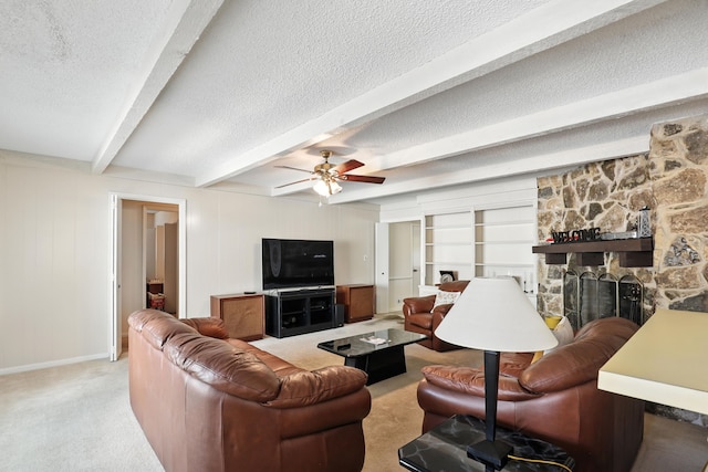 2910 Riata Ln, Houston, TX 77043 - living area with light colored carpet, a fireplace, ceiling fan, a textured ceiling, and beam ceiling