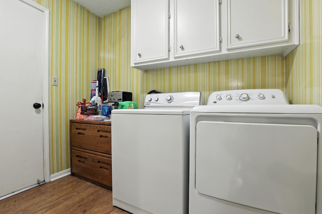 2910 Riata Ln, Houston, TX 77043 - washroom featuring wallpapered walls, washing machine and dryer, wood finished floors, and cabinet space