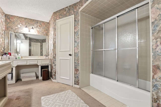 2910 Riata Ln, Houston, TX 77043 - bathroom featuring wallpapered walls, vanity, combined bath / shower with glass door, and a textured ceiling