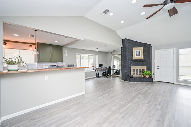 19923 Ricewood Way, Katy, TX 77449 - unfurnished living room with lofted ceiling, a ceiling fan, wood finished floors, a fireplace, and recessed lighting