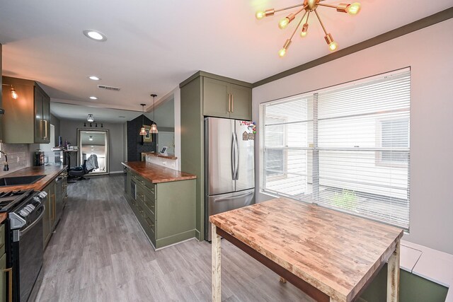 19923 Ricewood Way, Katy, TX 77449 - kitchen with freestanding refrigerator, stove, light wood-style floors, a chandelier, and butcher block countertops