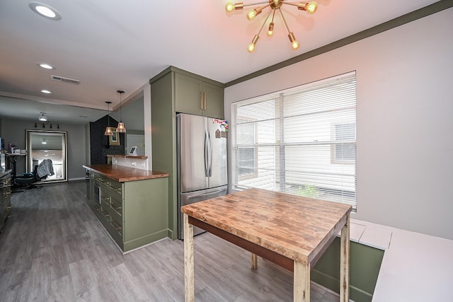 19923 Ricewood Way, Katy, TX 77449 - kitchen featuring green cabinetry, stainless steel fridge, a chandelier, wood finished floors, and recessed lighting