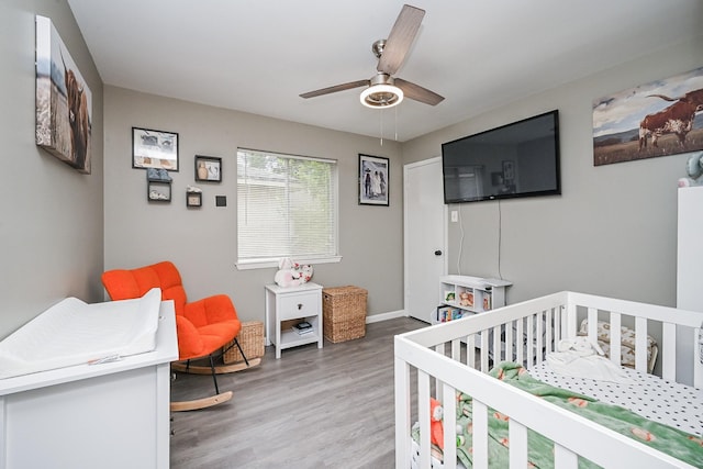 19923 Ricewood Way, Katy, TX 77449 - bedroom featuring a nursery area, light wood finished floors, and ceiling fan