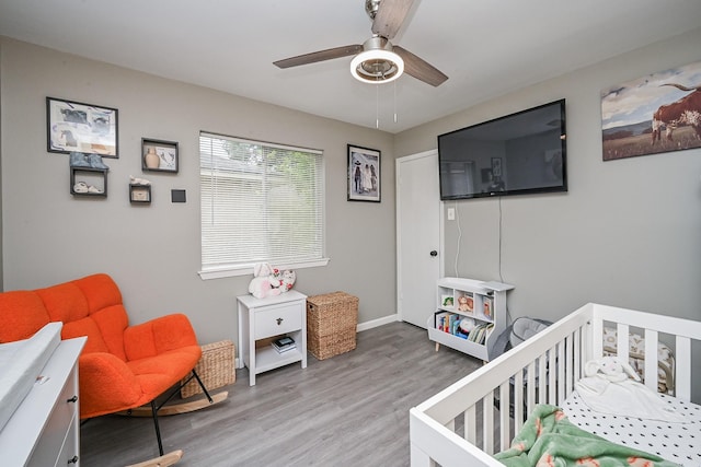 19923 Ricewood Way, Katy, TX 77449 - bedroom featuring wood finished floors, a crib, and ceiling fan