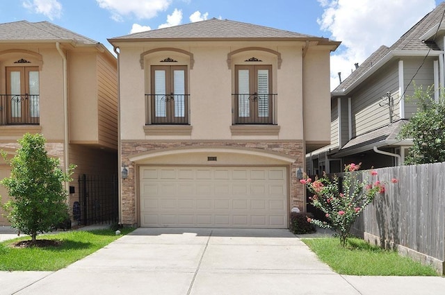 5325 Petty St Unit B, Houston, TX 77007 - view of front of home with french doors, an attached garage, stucco siding, and driveway