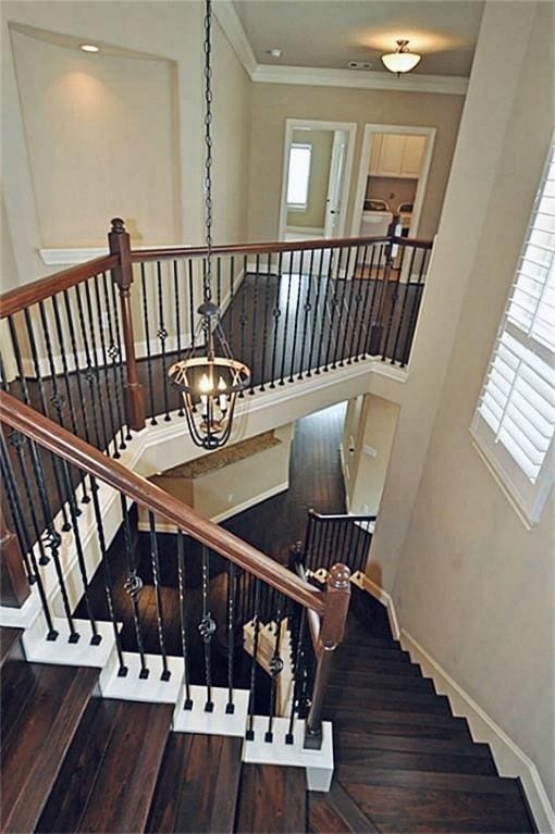 5325 Petty St Unit B, Houston, TX 77007 - stairs with wood finished floors, ornamental molding, plenty of natural light, and a chandelier