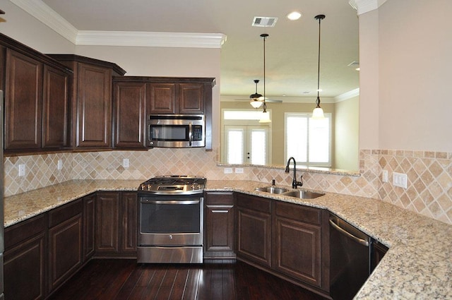 5325 Petty St Unit B, Houston, TX 77007 - kitchen featuring stainless steel appliances, ceiling fan, dark brown cabinetry, light stone countertops, and crown molding