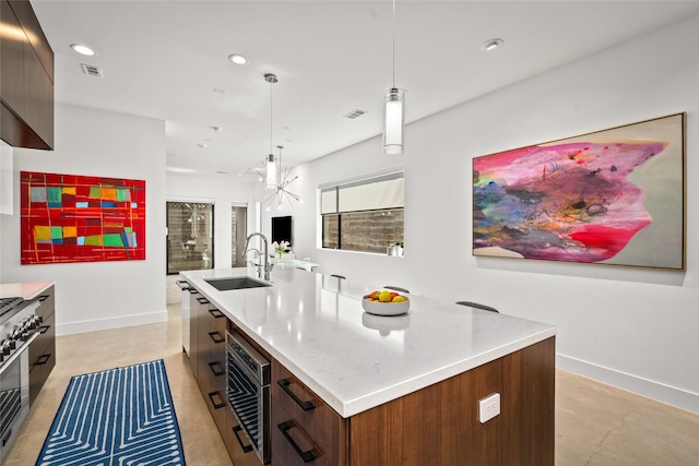 509 W Drew St, Houston, TX 77006 - kitchen with gas stove, modern cabinets, an island with sink, recessed lighting, and pendant lighting