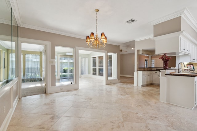 6606 Preston Trail Dr, Houston, TX 77069 - kitchen featuring dark countertops, a chandelier, crown molding, open floor plan, and white cabinetry