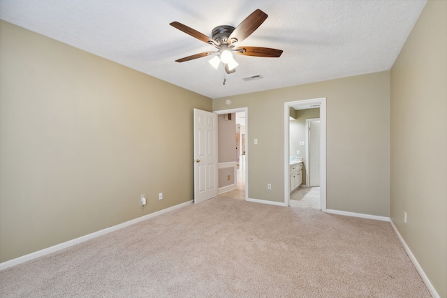 6606 Preston Trail Dr, Houston, TX 77069 - unfurnished bedroom with light carpet, connected bathroom, and a ceiling fan