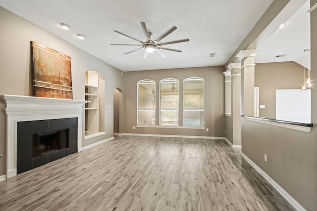 15919 Shadow Pass Trl, Tomball, TX 77377 - unfurnished living room with ceiling fan, wood finished floors, and a tiled fireplace